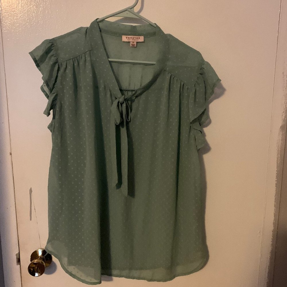 pale green sleeveless blouse